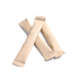 Beige sticks of sugar on white background