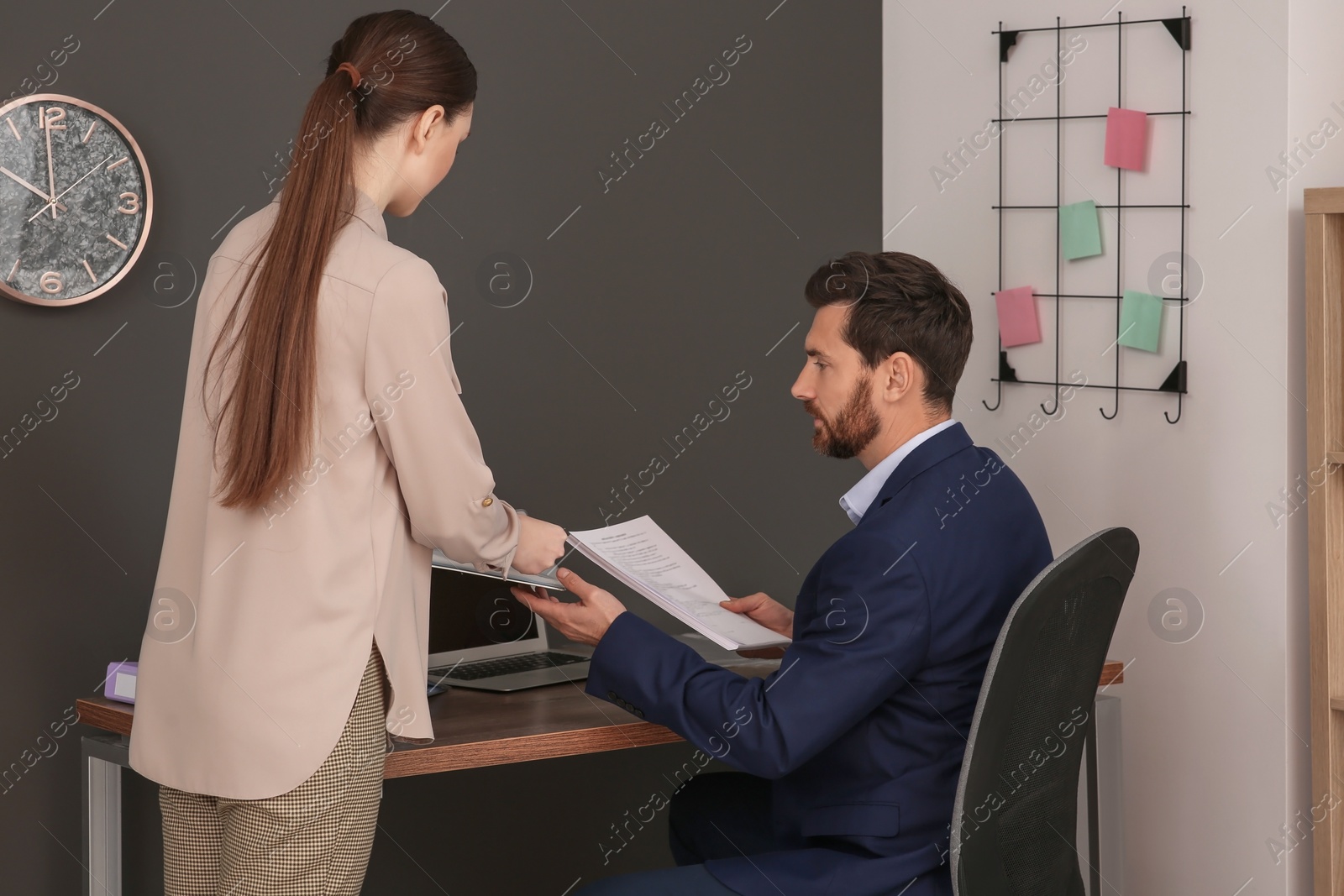 Photo of Businesspeople working together with documents in office