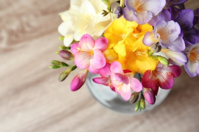 Photo of Beautiful bouquet of freesia flowers on table