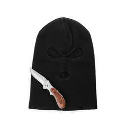 Photo of Black knitted balaclava and knife on white background, top view