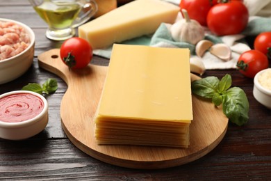 Photo of Uncooked ingredients for lasagna on wooden table