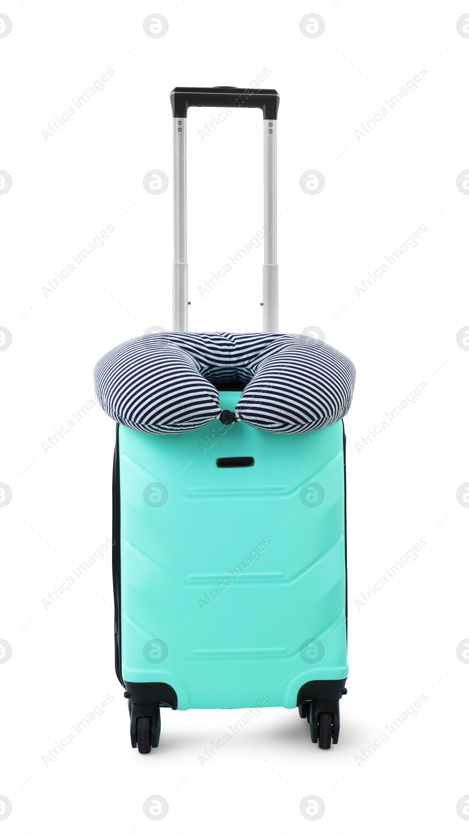 Photo of Soft travel pillow on turquoise suitcase isolated on white