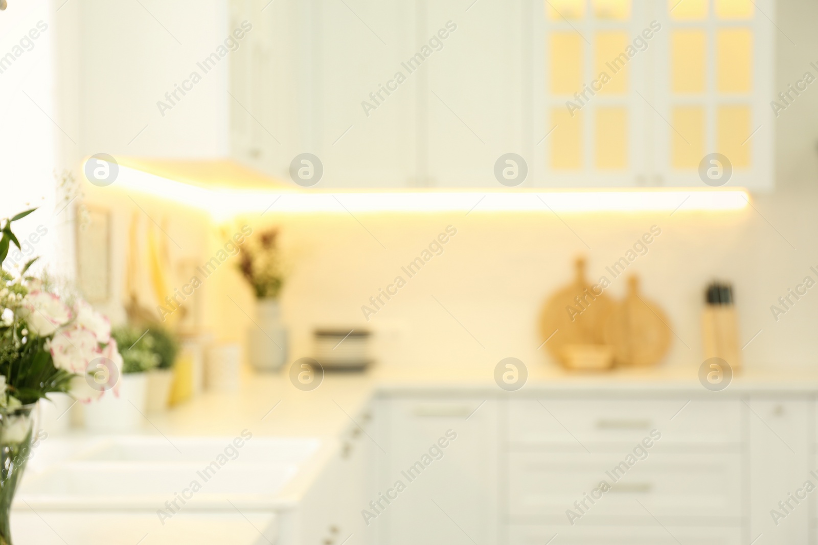 Photo of Blurred view of modern kitchen interior with stylish furniture