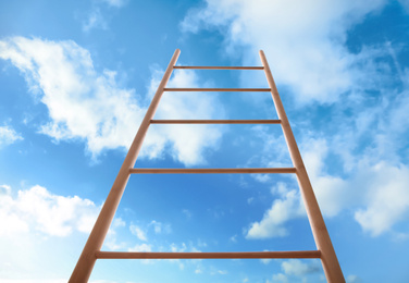 Image of Wooden ladder against blue sky with clouds, low angle view
