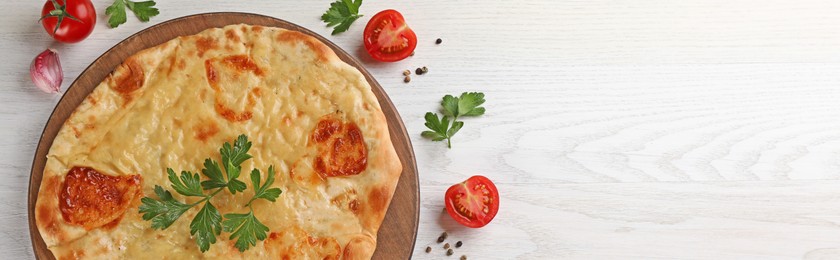 Delicious Megrelian khachapuri served on white wooden table, flat lay. Banner design with space for text