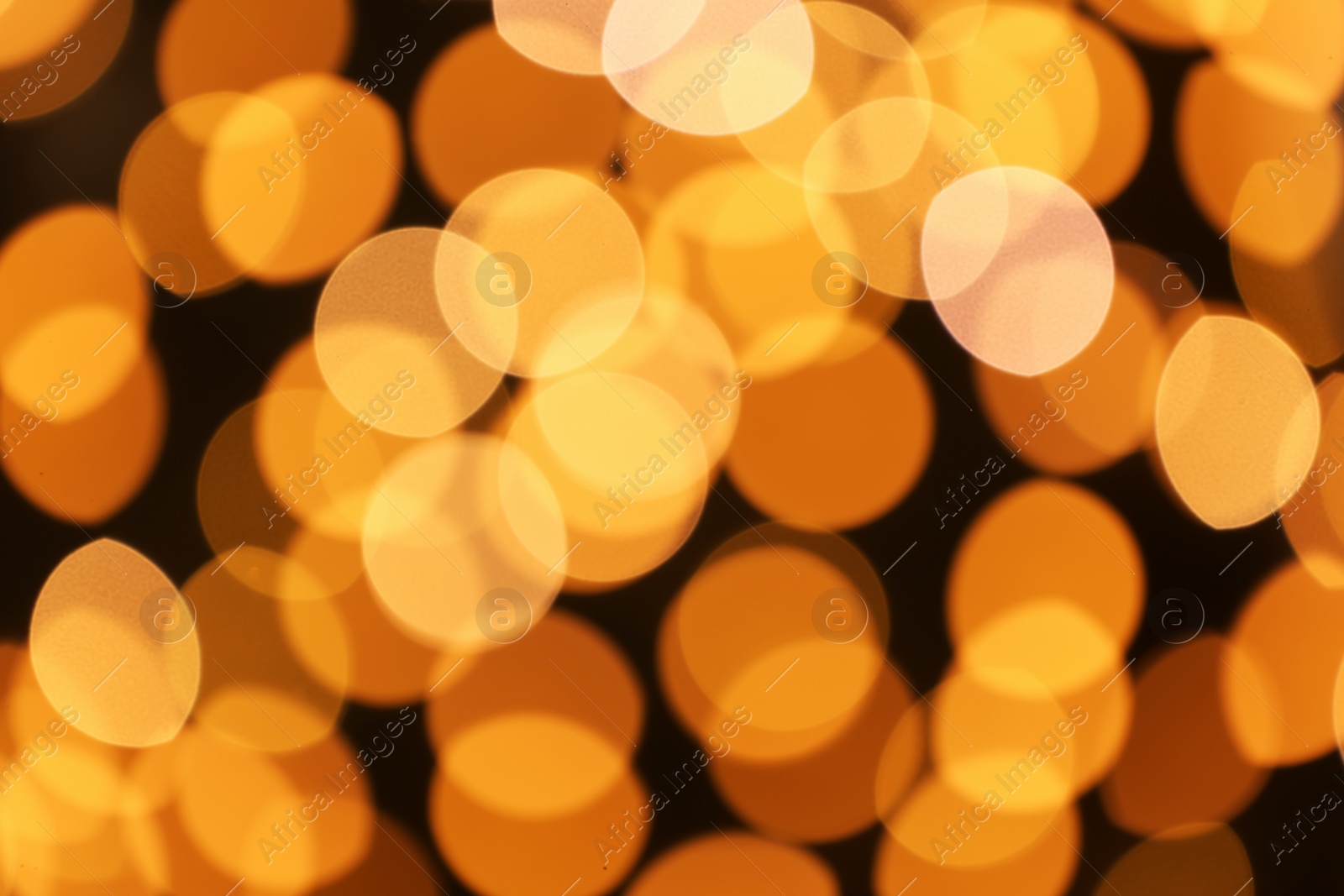 Photo of Beautiful golden lights on dark background. Bokeh effect