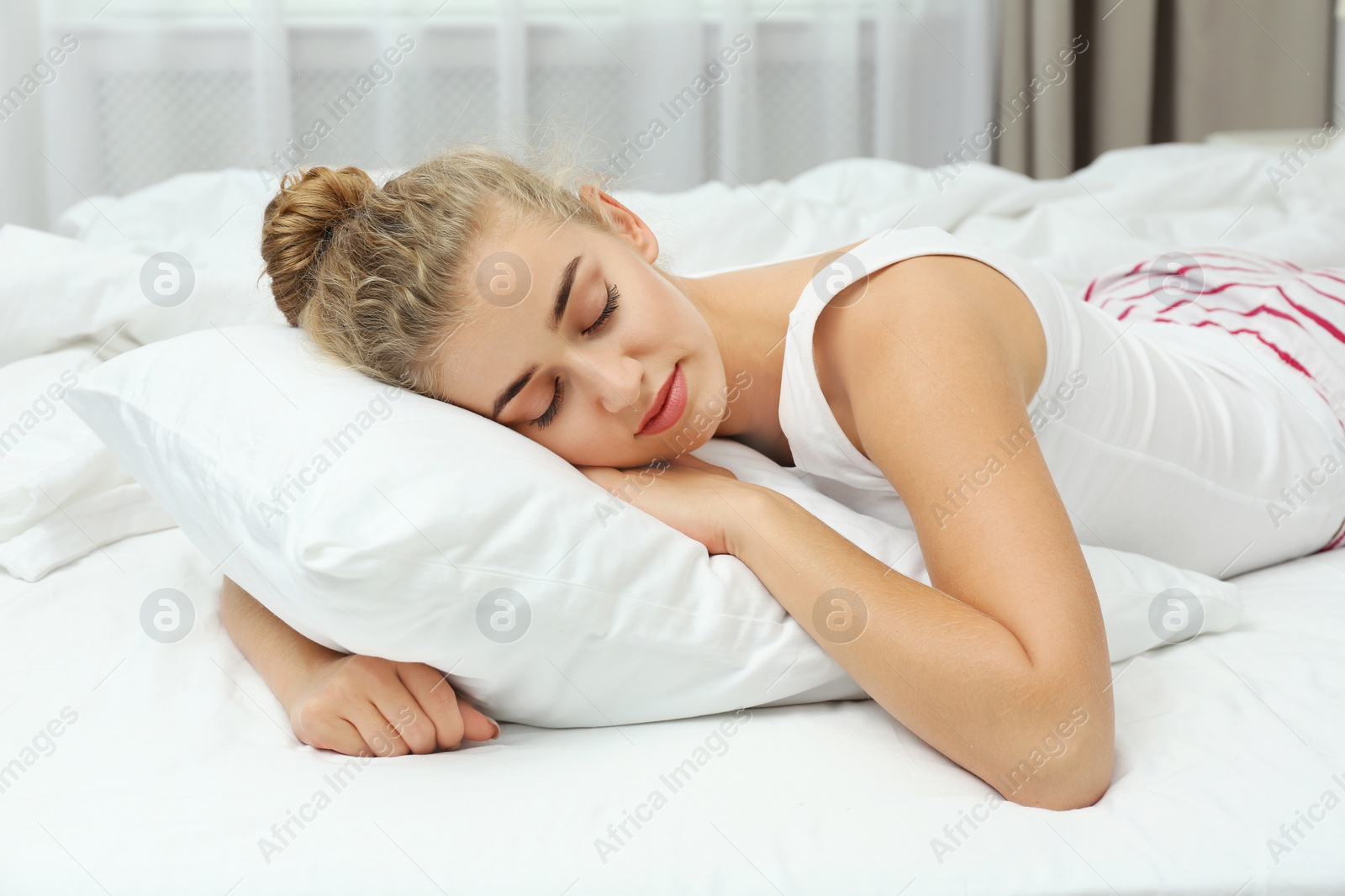 Photo of Beautiful woman sleeping with comfortable pillow on bed at home