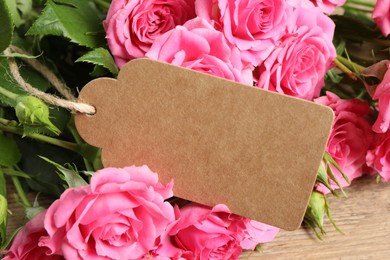 Photo of Happy Mother's Day. Beautiful flowers and blank card on wooden table, closeup