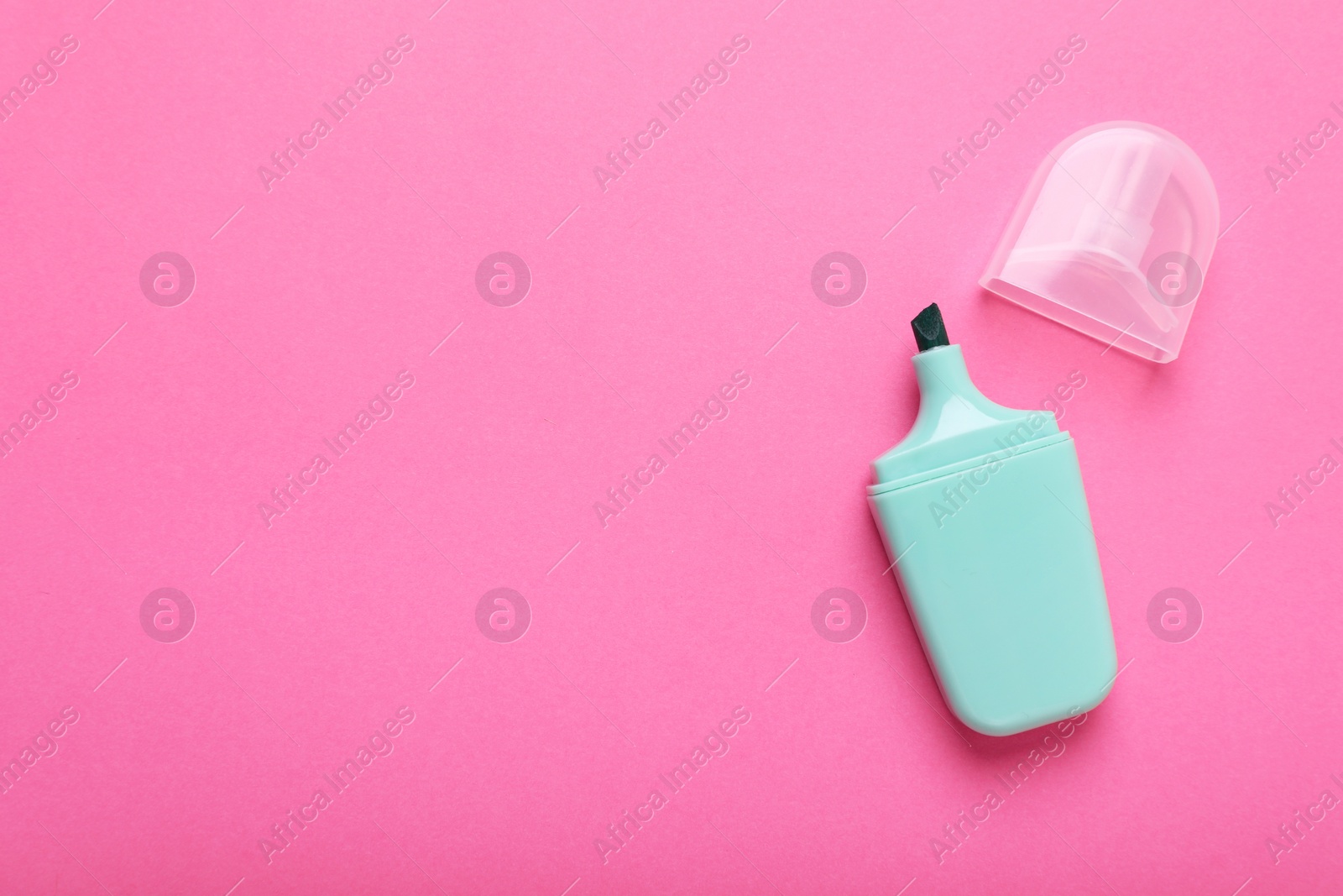 Photo of One marker with cap on pink background, top view. Space for text