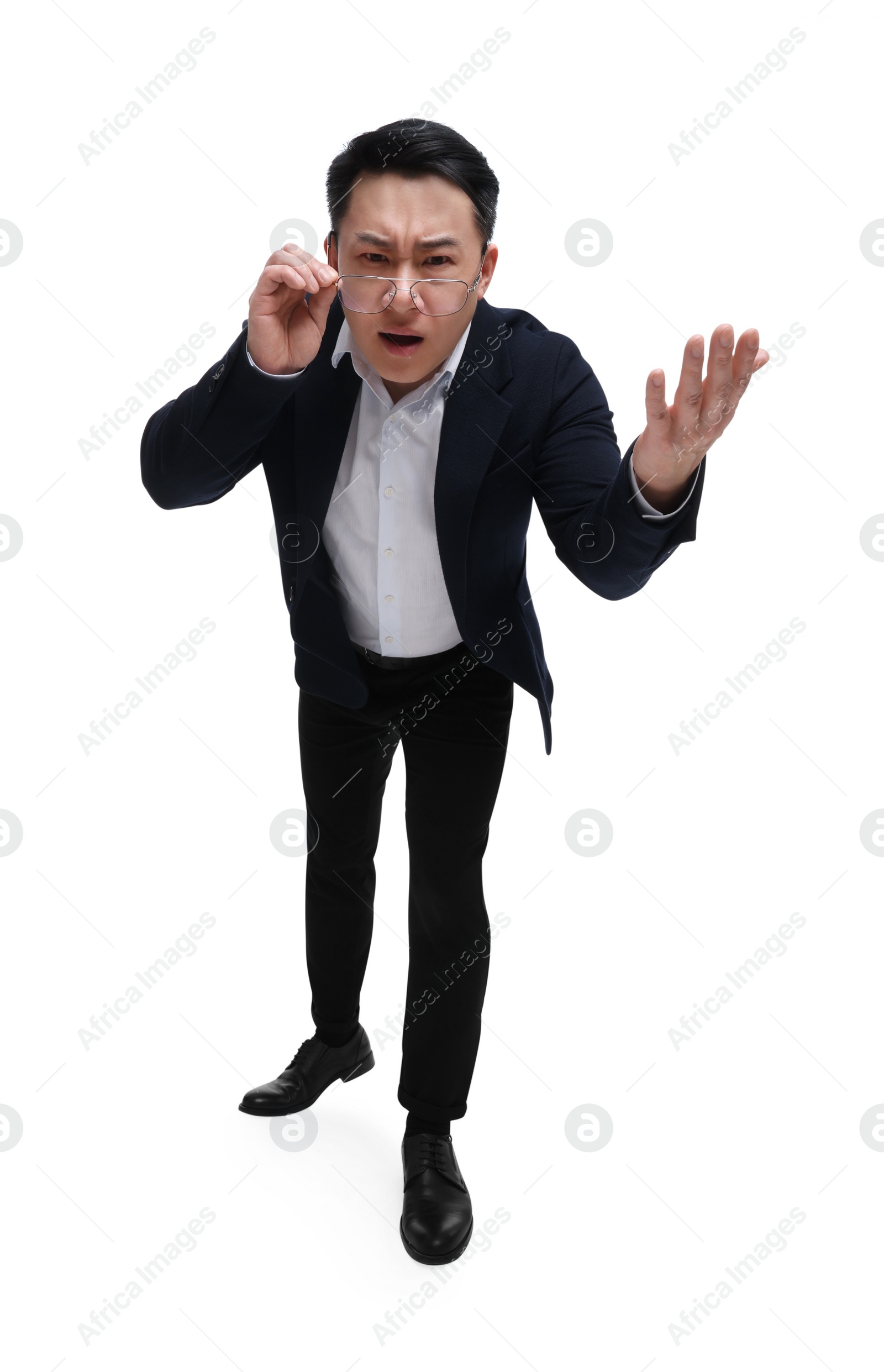 Photo of Angry businessman in suit wearing glasses on white background, low angle view