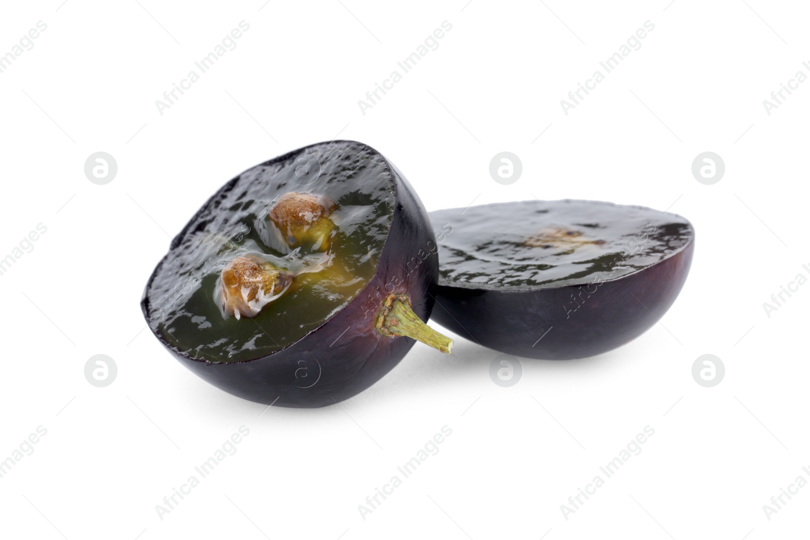 Photo of Halves of dark blue grape isolated on white