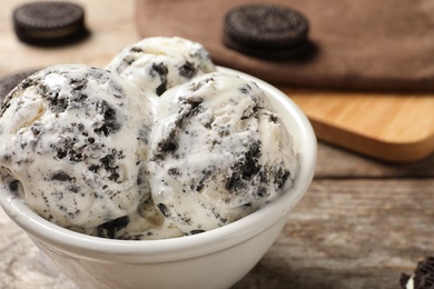 Bowl of chocolate cookies ice cream on table, closeup