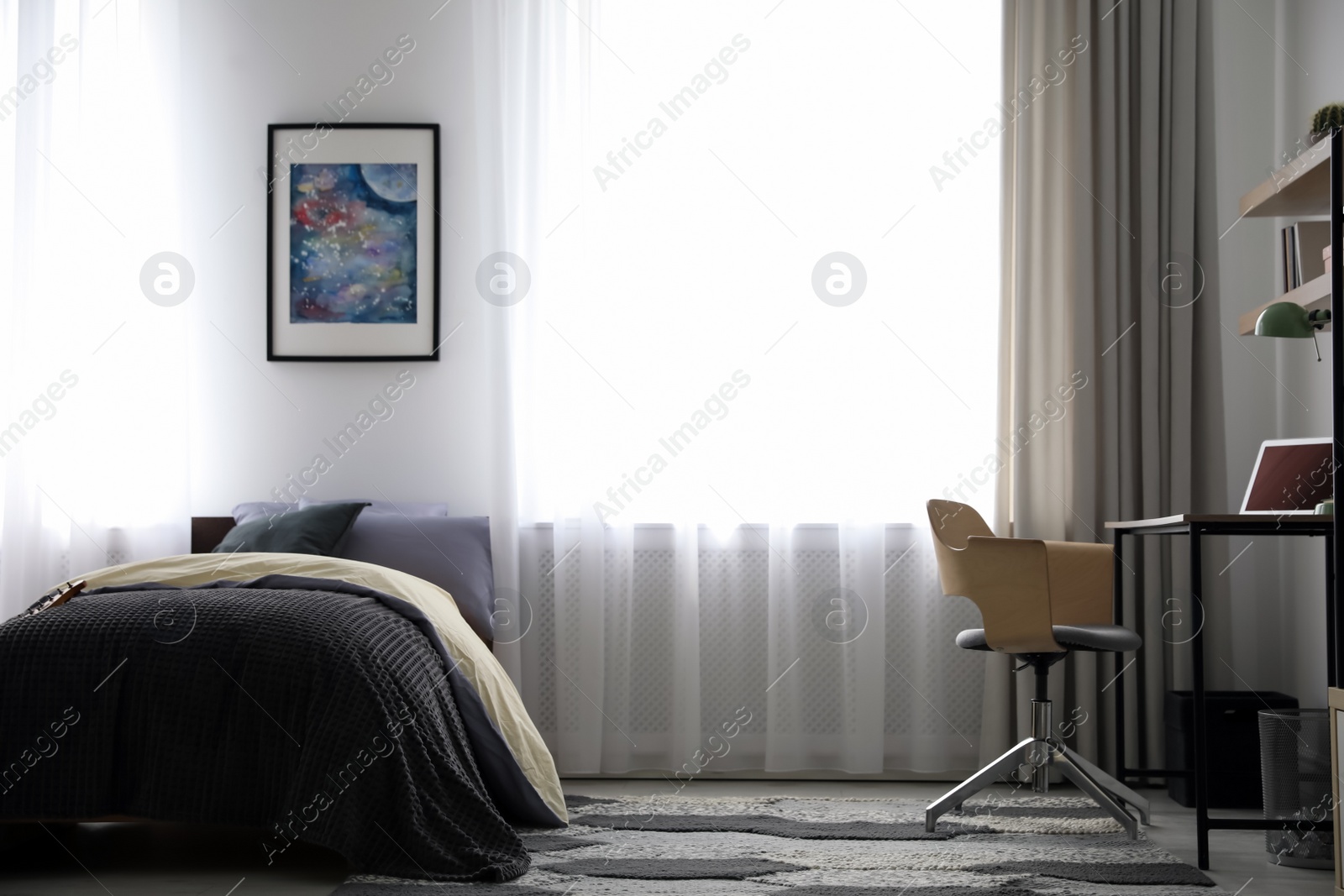 Photo of Modern teenager's room interior with workplace and bed