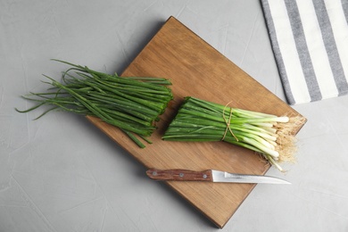 Beautiful composition with fresh green onion on wooden table, top view