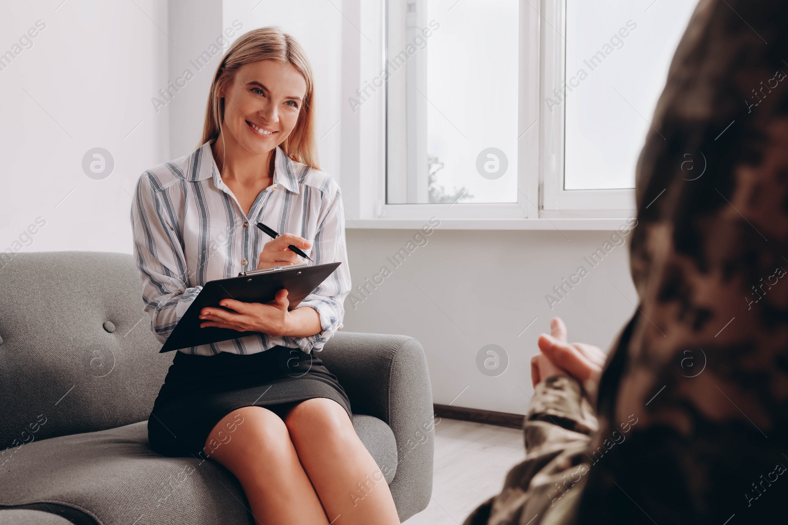 Photo of Psychologist working with female military officer in office