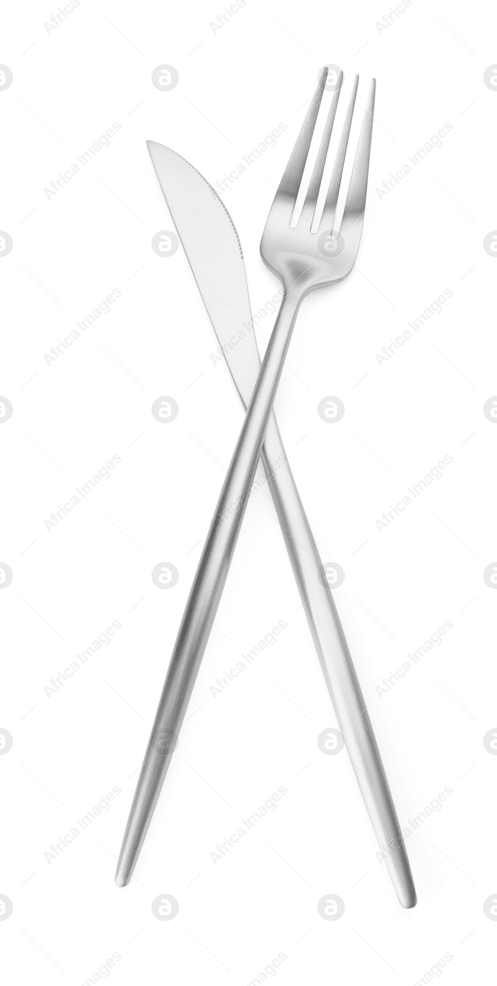 Photo of Shiny silver fork and knife isolated on white. Luxury cutlery