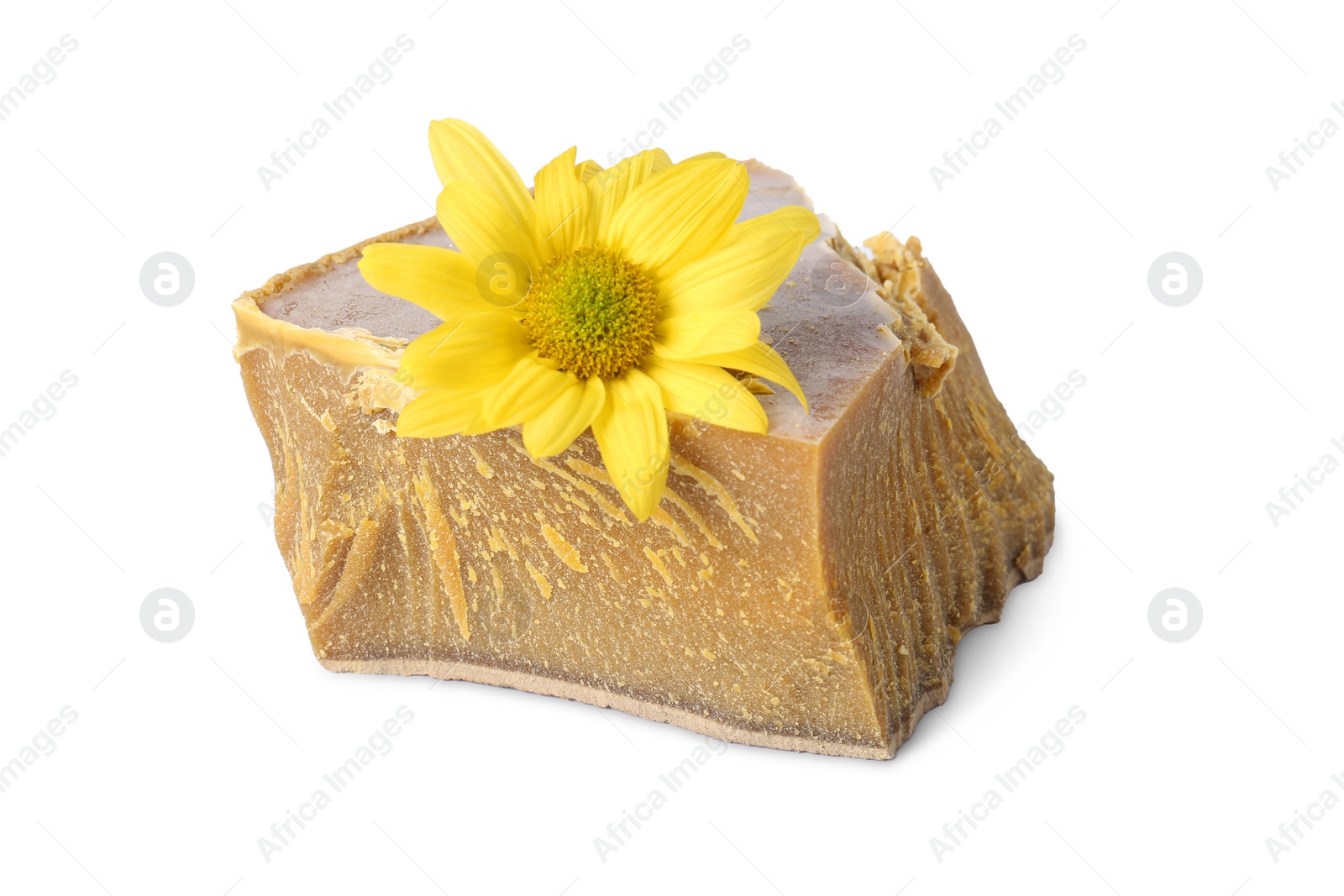 Photo of Natural organic beeswax block and flower isolated on white