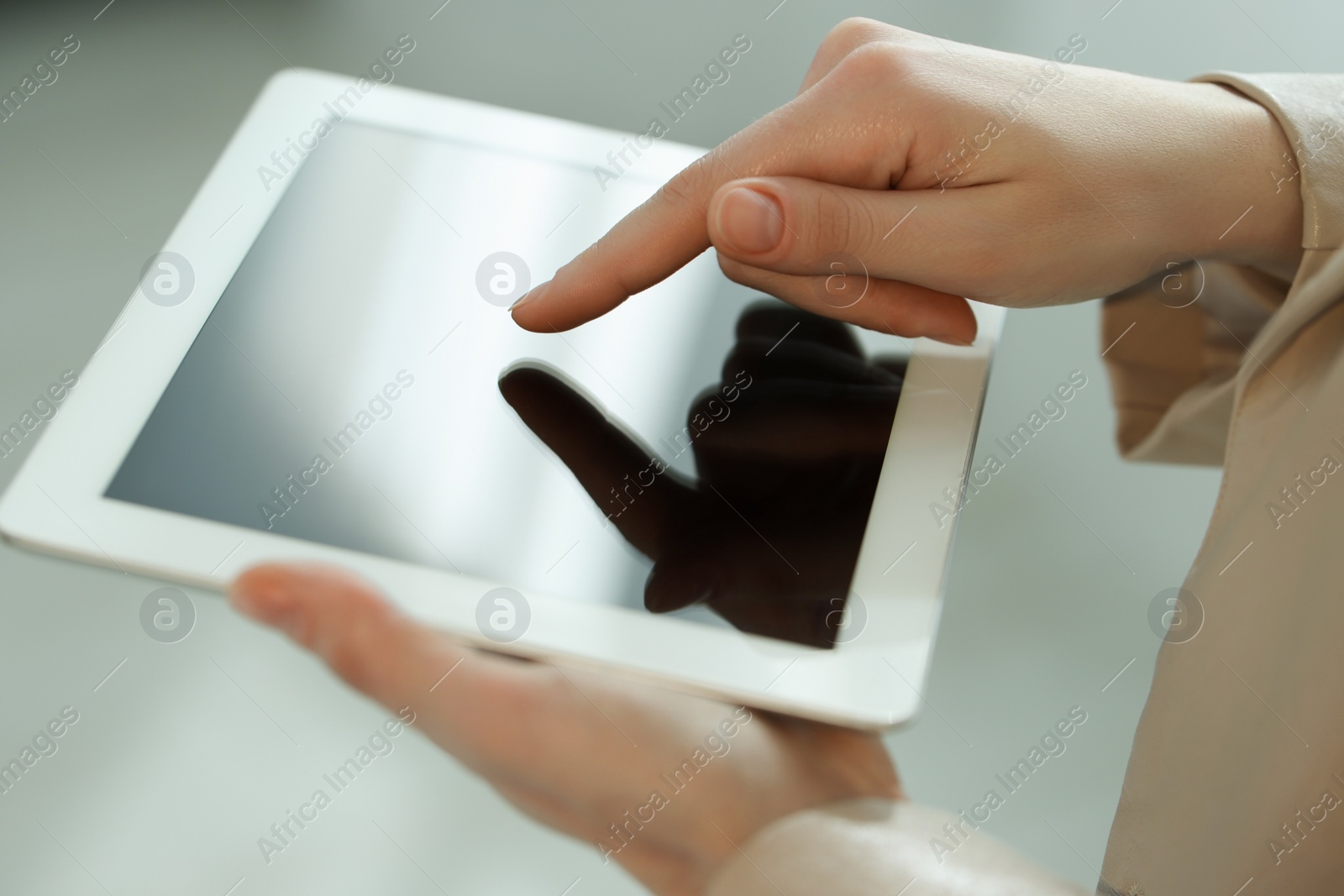 Photo of Closeup view of woman using modern tablet on blurred background