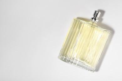 Photo of Luxury men`s perfume in bottle on white background, top view. Space for text