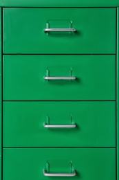 Photo of Green wardrobe drawers as background, closeup view