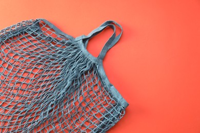 Photo of Blue string bag on red background, top view. Space for text