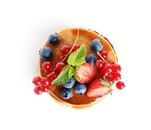 Delicious pancakes with fresh berries and syrup on white background, top view