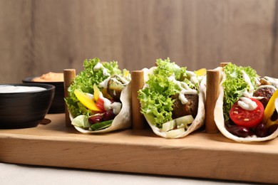 Delicious fresh vegan tacos served on wooden table