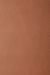 Photo of Texture of light brown leather as background, closeup