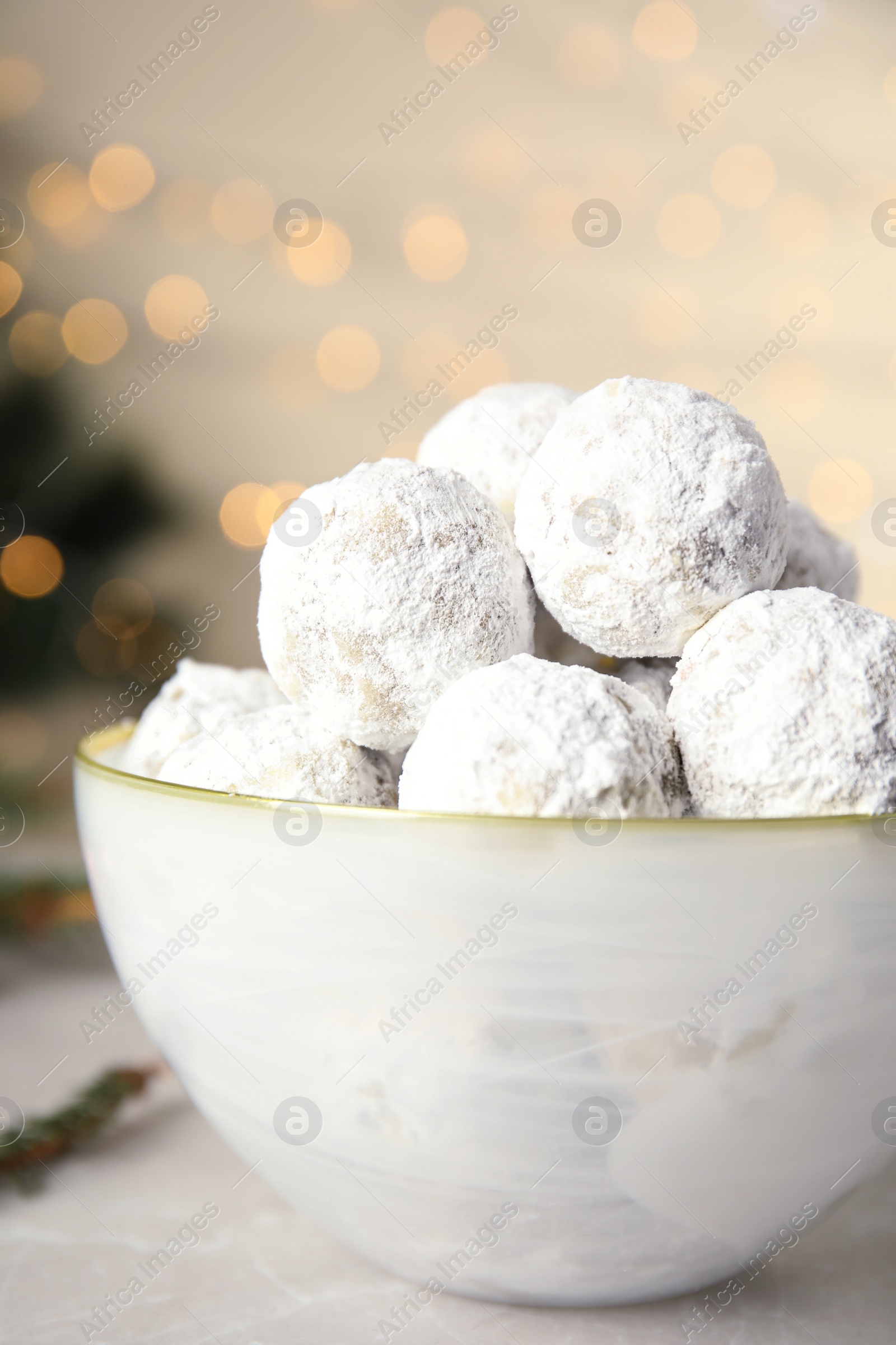 Photo of Tasty snowball cookies in light bowl, closeup, Christmas treat