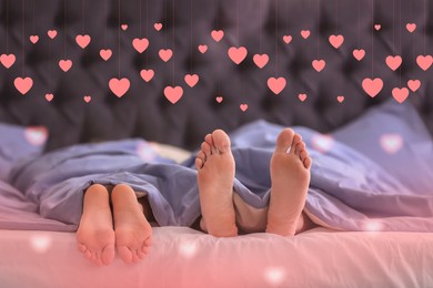 Image of Closeup view of young couple in bed at home and illustration of cute pink hearts