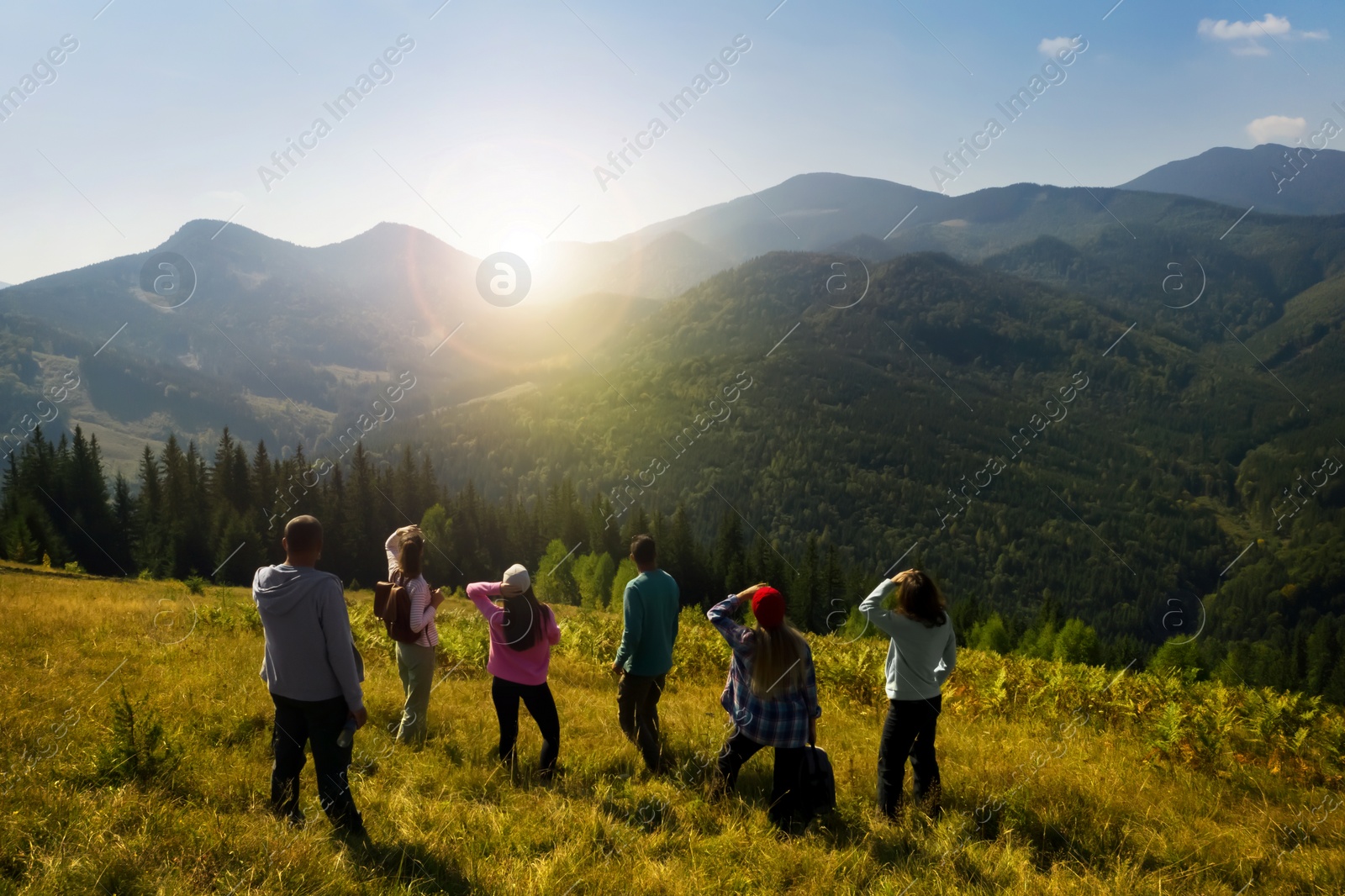 Image of Group of tourists on hill in mountains. Drone photography