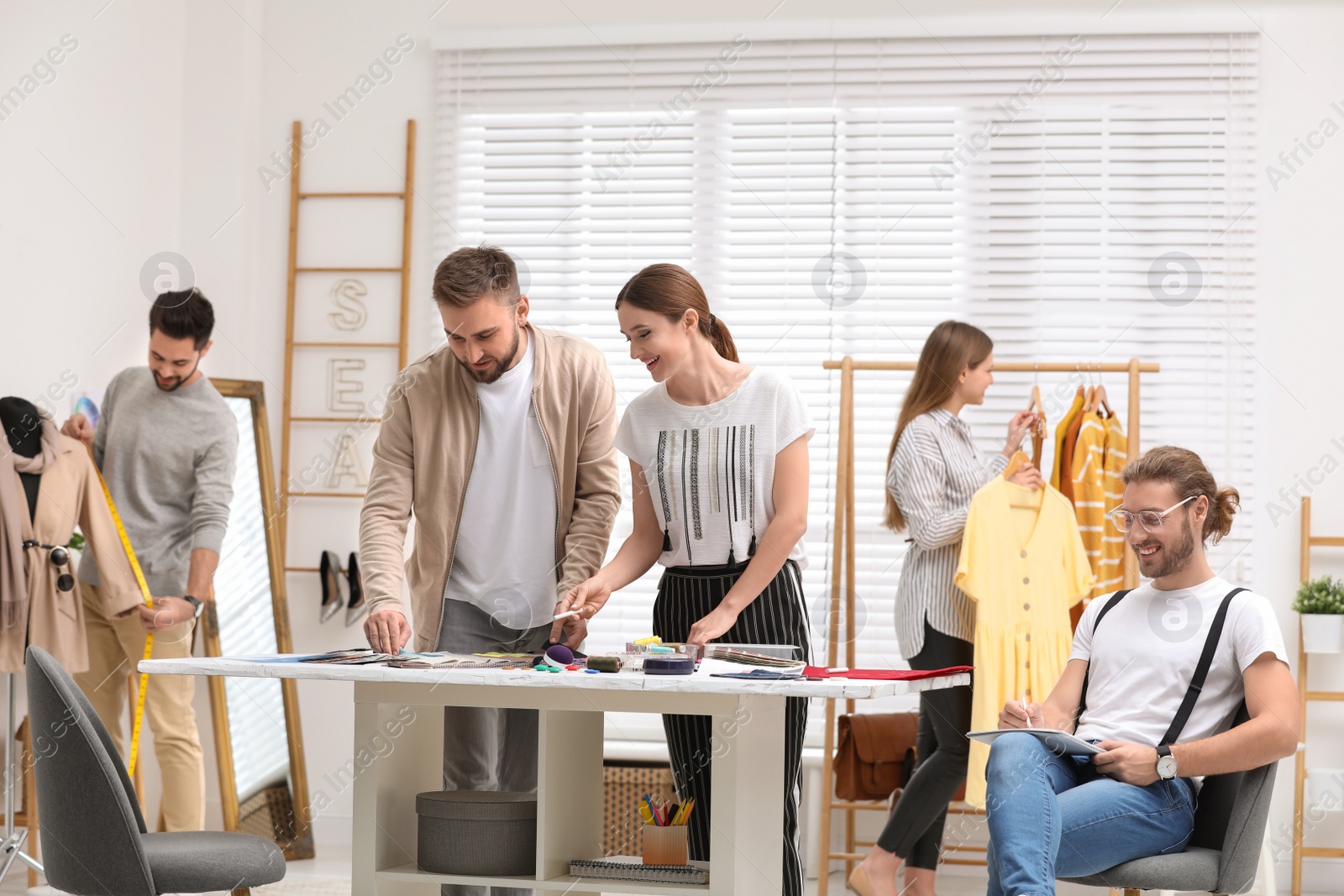 Photo of Fashion designers creating new clothes in studio