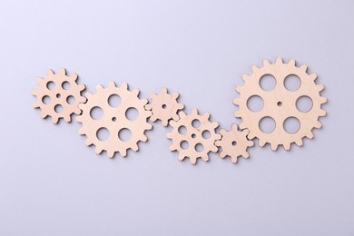 Business process organization and optimization. Scheme with wooden figures on light background, top view