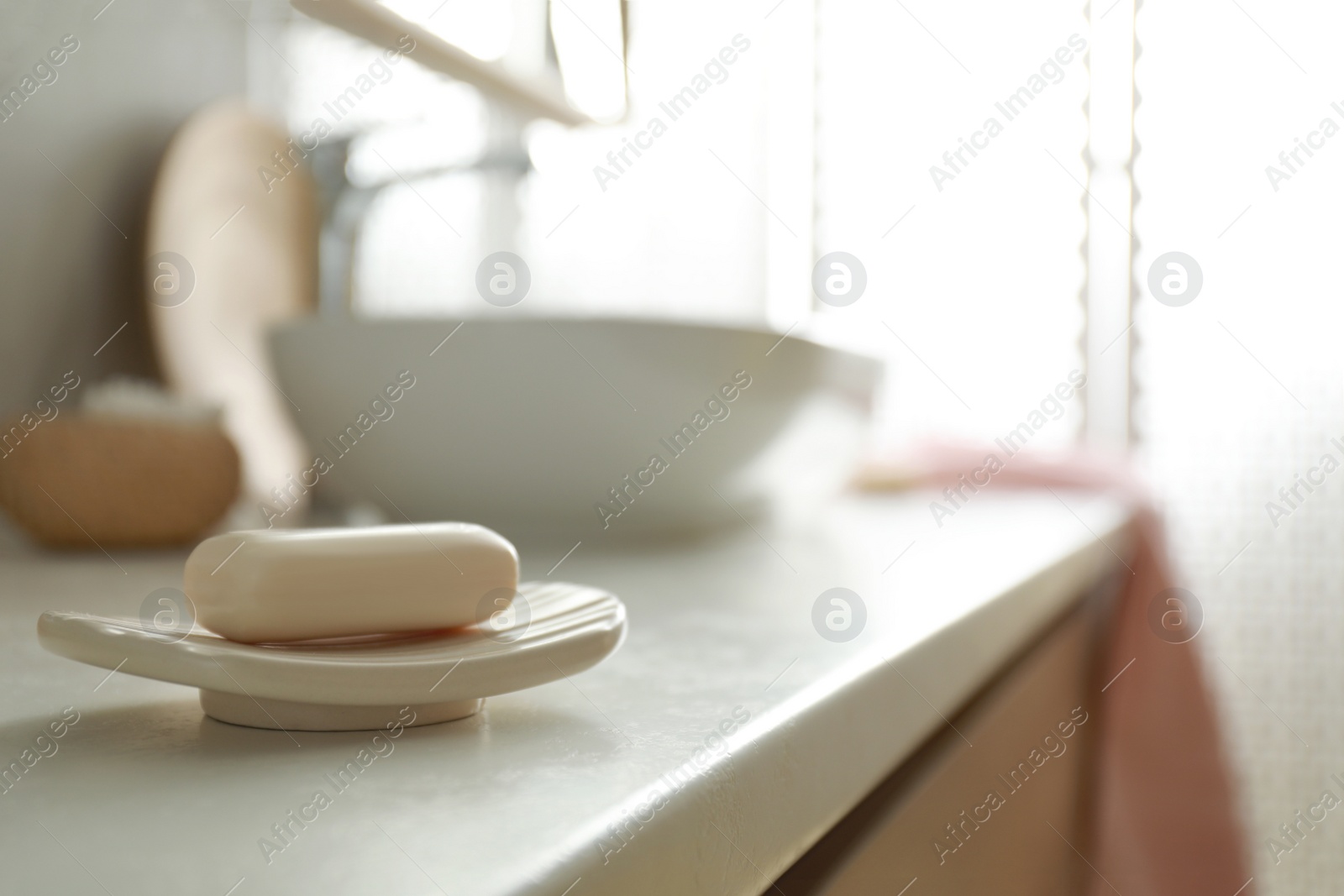 Photo of Bar of soap on countertop in modern bathroom interior
