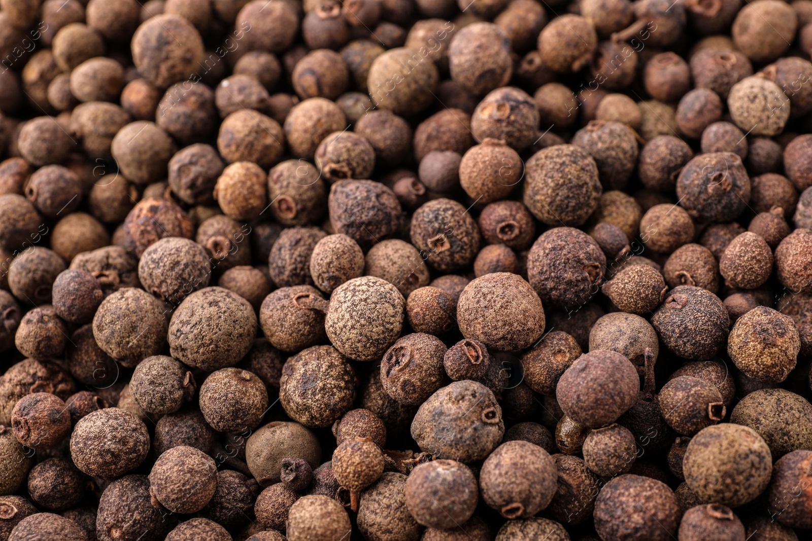 Photo of Black pepper grains as background, closeup view