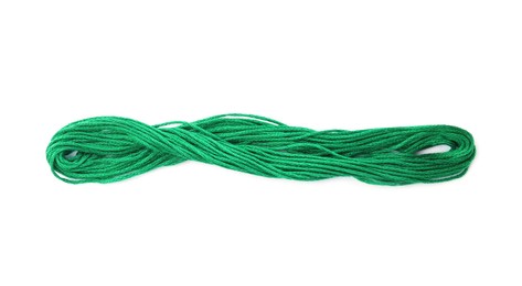 Bright green embroidery thread on white background