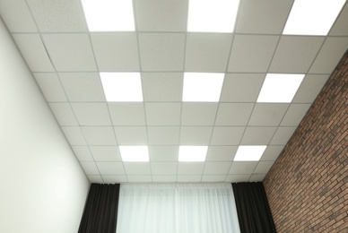 Photo of White ceiling with lighting in office room