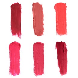 Smears of different beautiful lipsticks on white background, top view