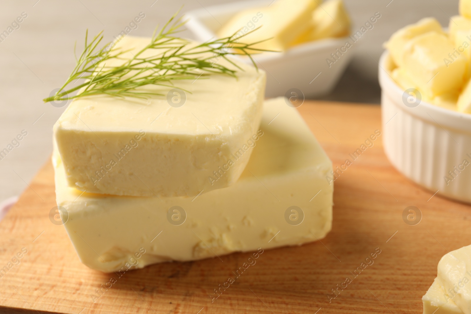 Photo of Tasty butter with dill on wooden table, closeup