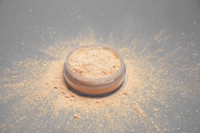 Photo of Loose face powder on light grey background, closeup