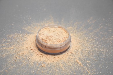 Loose face powder on light grey background, closeup