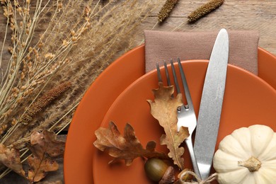 Festive table setting with autumn decor on wooden background, flat lay