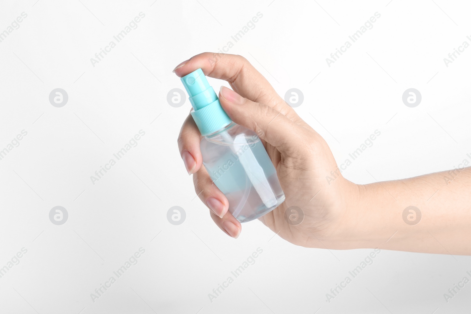 Photo of Woman holding antiseptic spray on white background, closeup