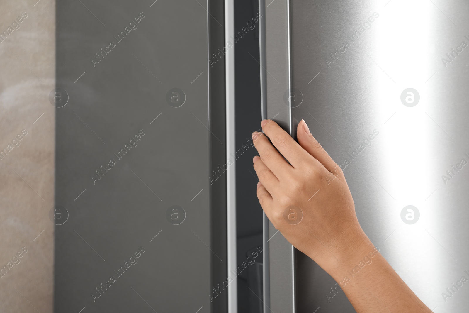 Photo of Woman opening refrigerator door, closeup. Space for text