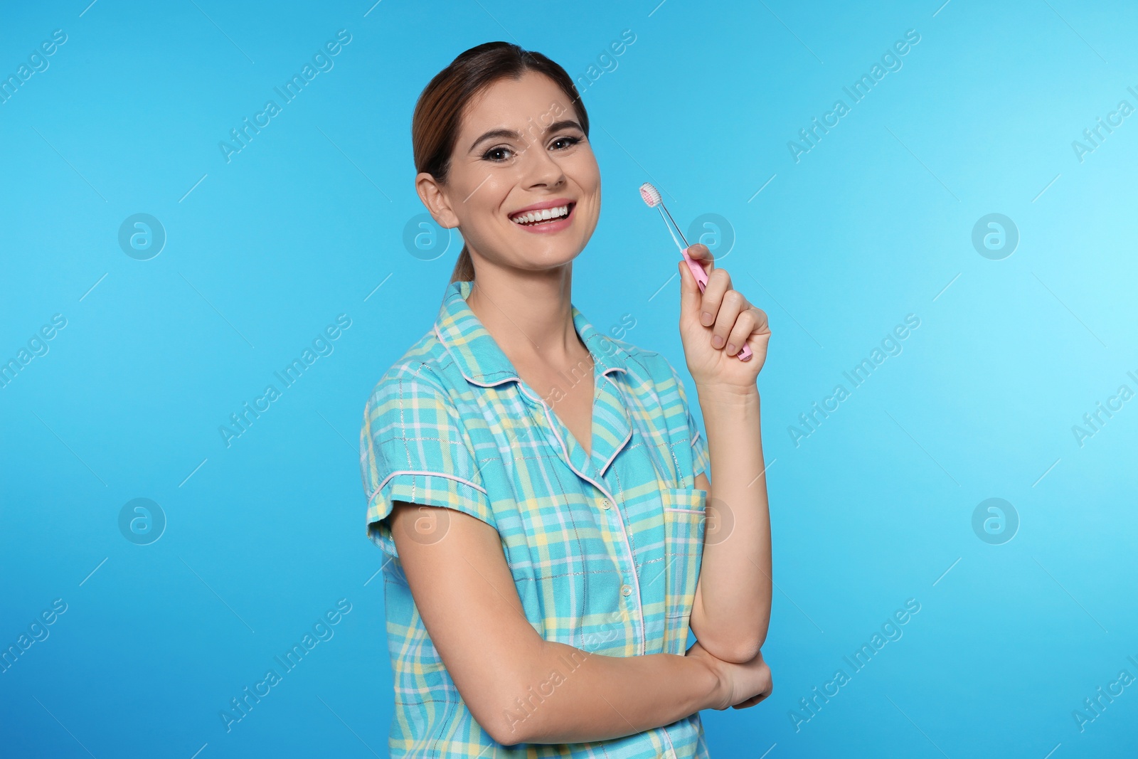 Photo of Portrait of woman with toothbrush on color background