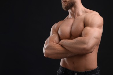 Muscular man on black background, closeup and space for text. Sexy body