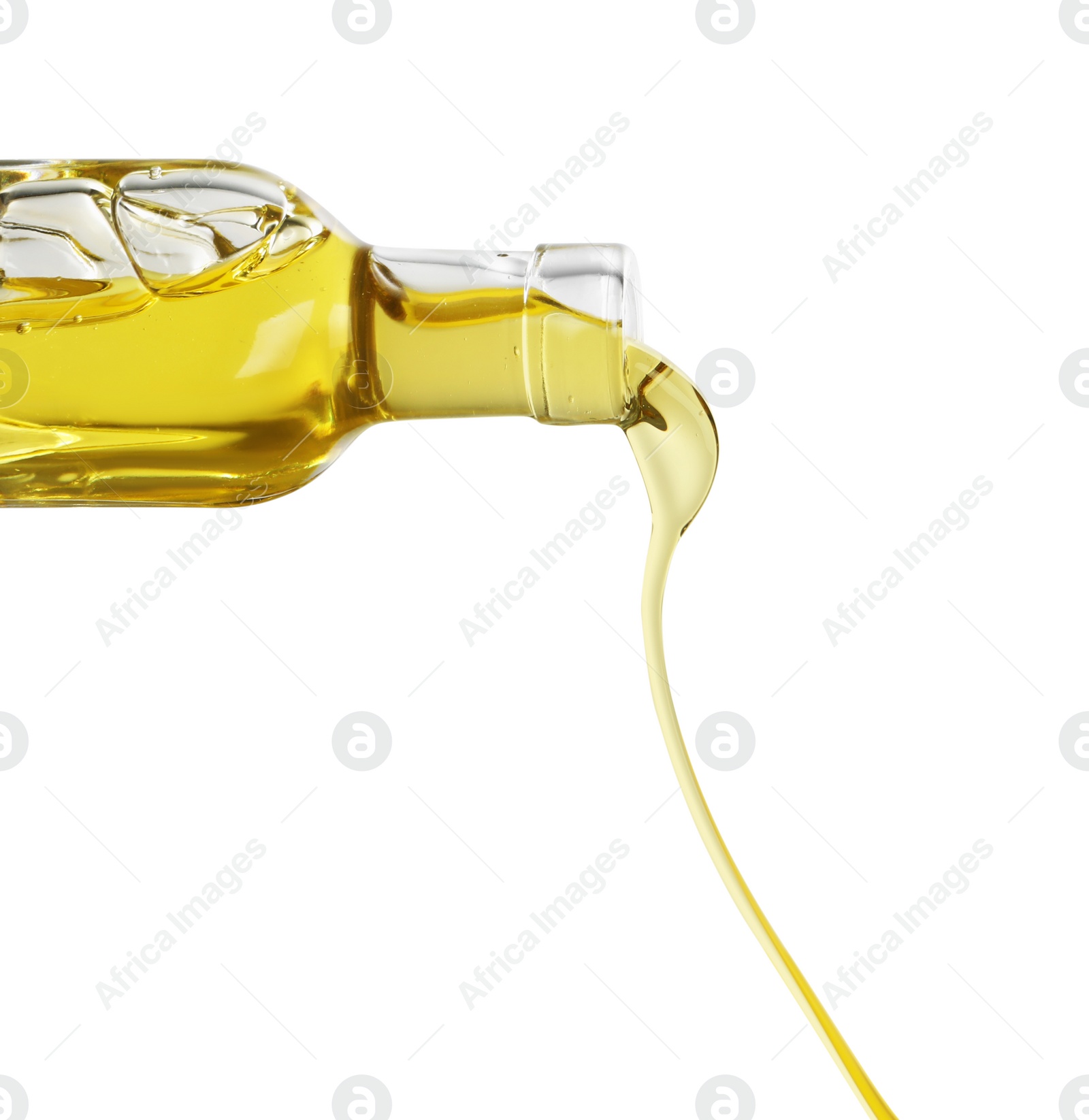 Photo of Pouring cooking oil from bottle on white background, closeup