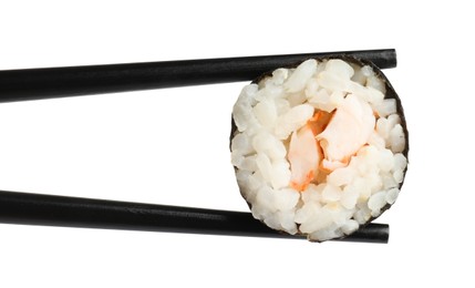 Photo of Chopsticks with tasty fresh sushi roll isolated on white