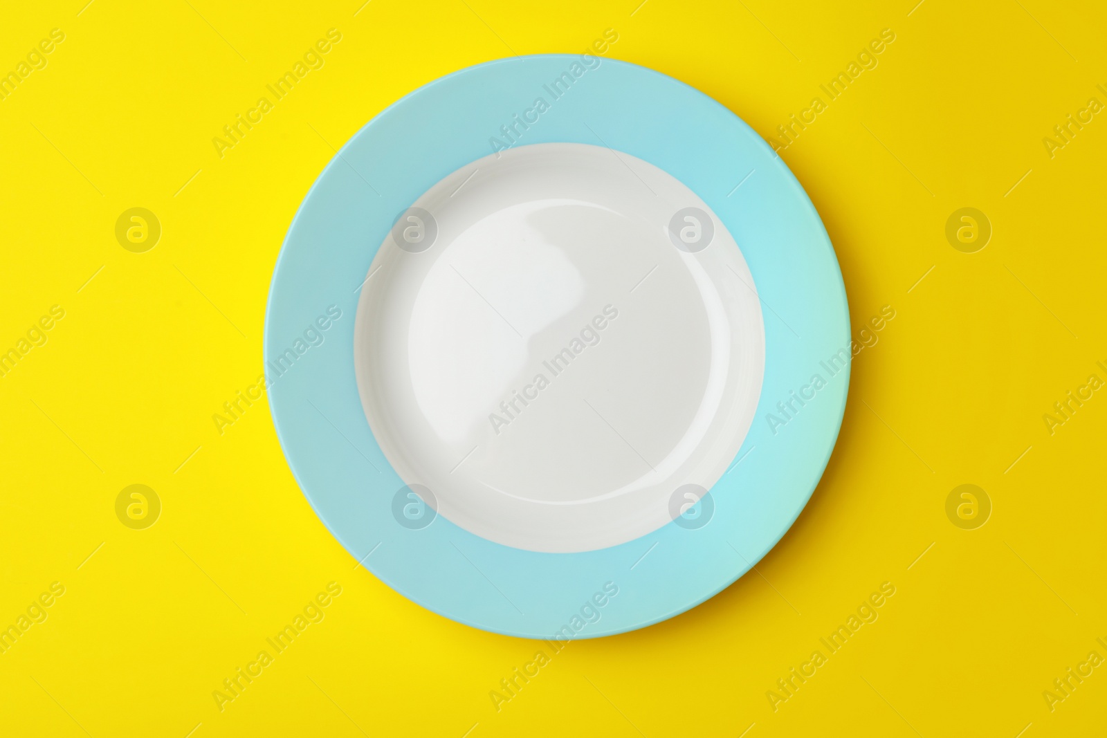 Photo of Clean empty plate on color background, top view