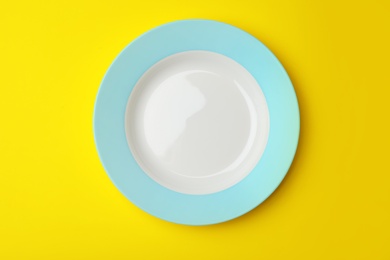 Photo of Clean empty plate on color background, top view